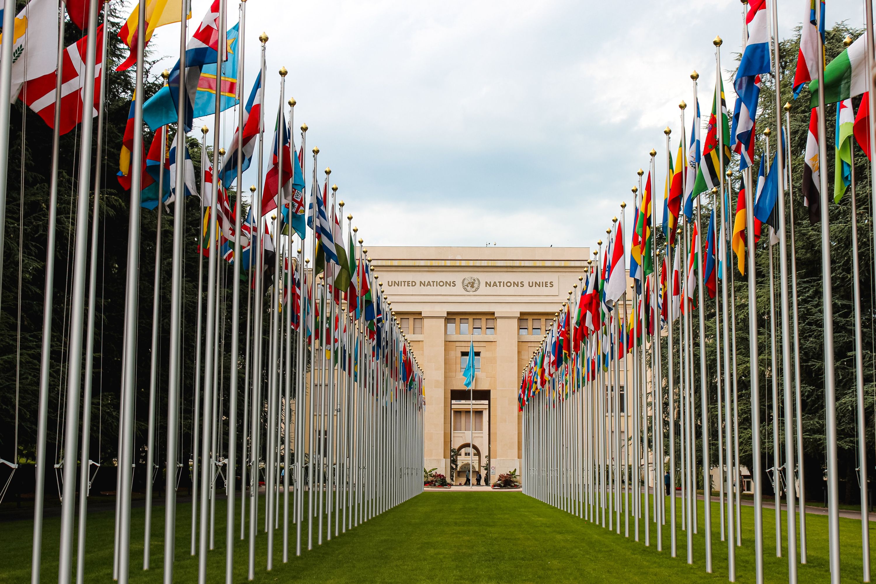 front of the United Nations Peace Palace in Geneva with two rows of flags