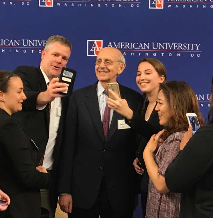 Associate Justice Breyer taking selfies with students.