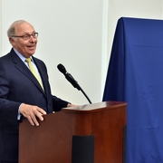 Dean Grossman giving remarks before his portrait is unveiled.
