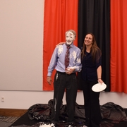 Professor Paul Figley gets pied by a student, who won the bid