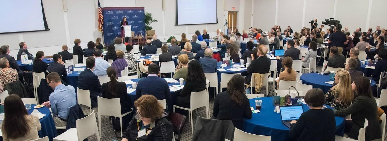 People gathered in a conference listening to a speech