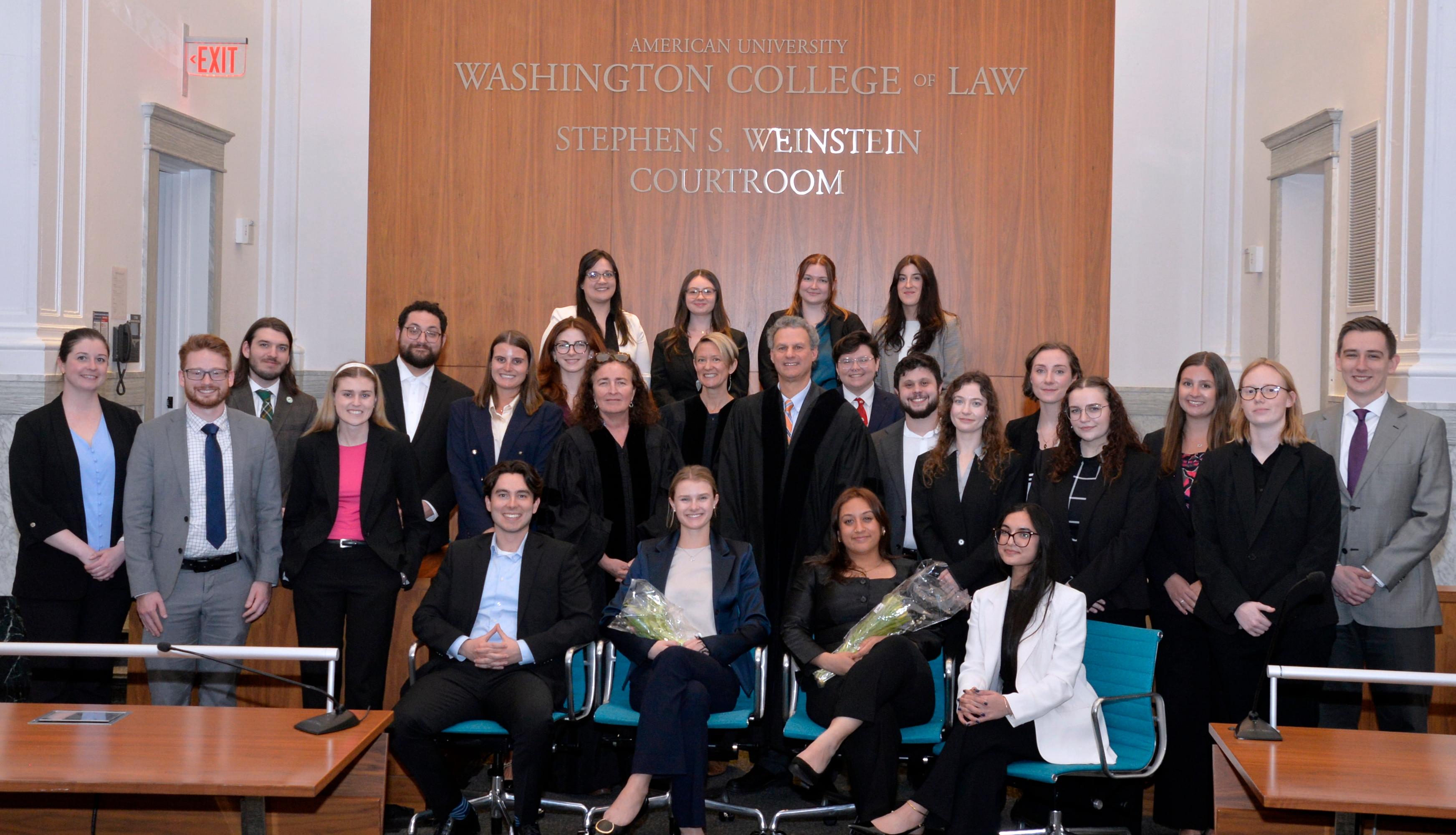 Members of the Moot Court Honor Society pose with faculty judges following the 2026 Alvina Reckman-Myers First Year Moot Court Tournament. Student organizers Sophie Putrim and Anika Krishnan (center) were presented with flowers in recognition of their dedication and leadership in organizing the competition.