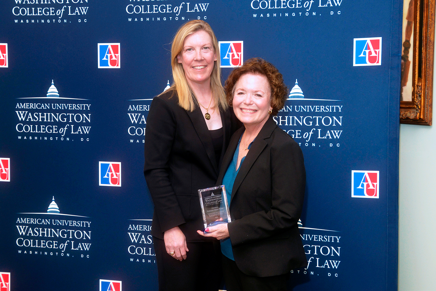 Professor Adeen Postar holding her esteemed service recognition award.