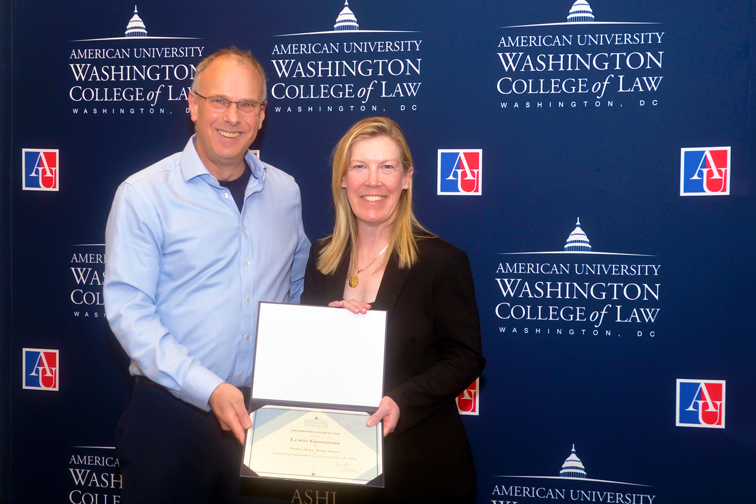 Professor Lewis Grossman receives the Pauline Ruyle Moore Award from Interim Dean Heather Hughes.