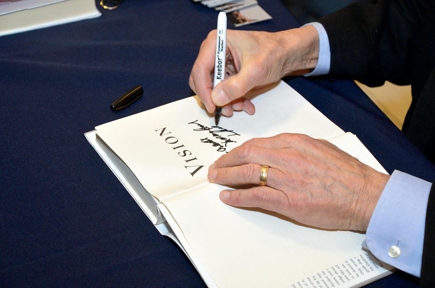 Judge Tatel autographs a copy of his book