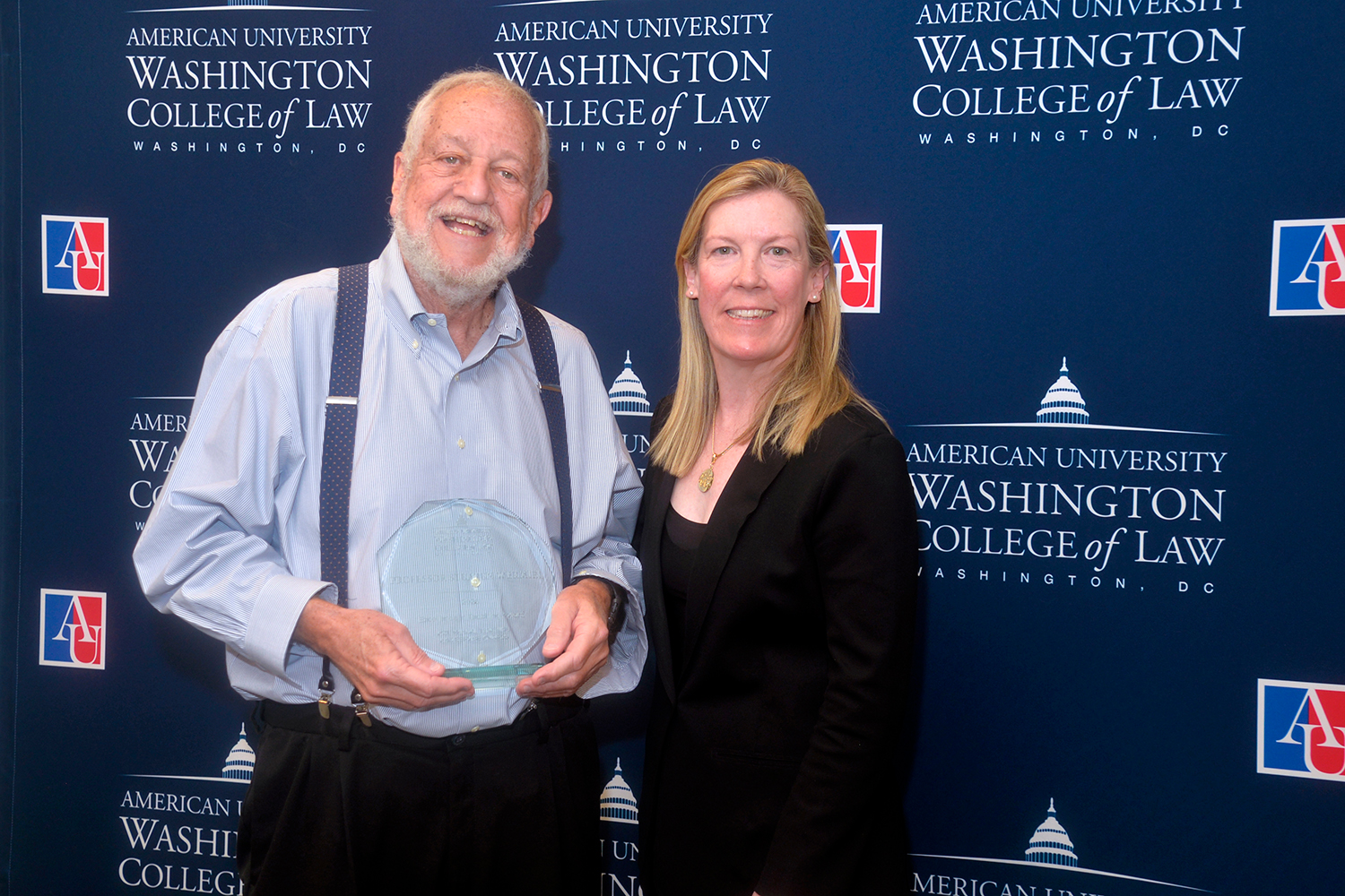 Professor Steve Wermiel with his Excellence in Teaching Award standing with Interim Dean Heather Hughes.